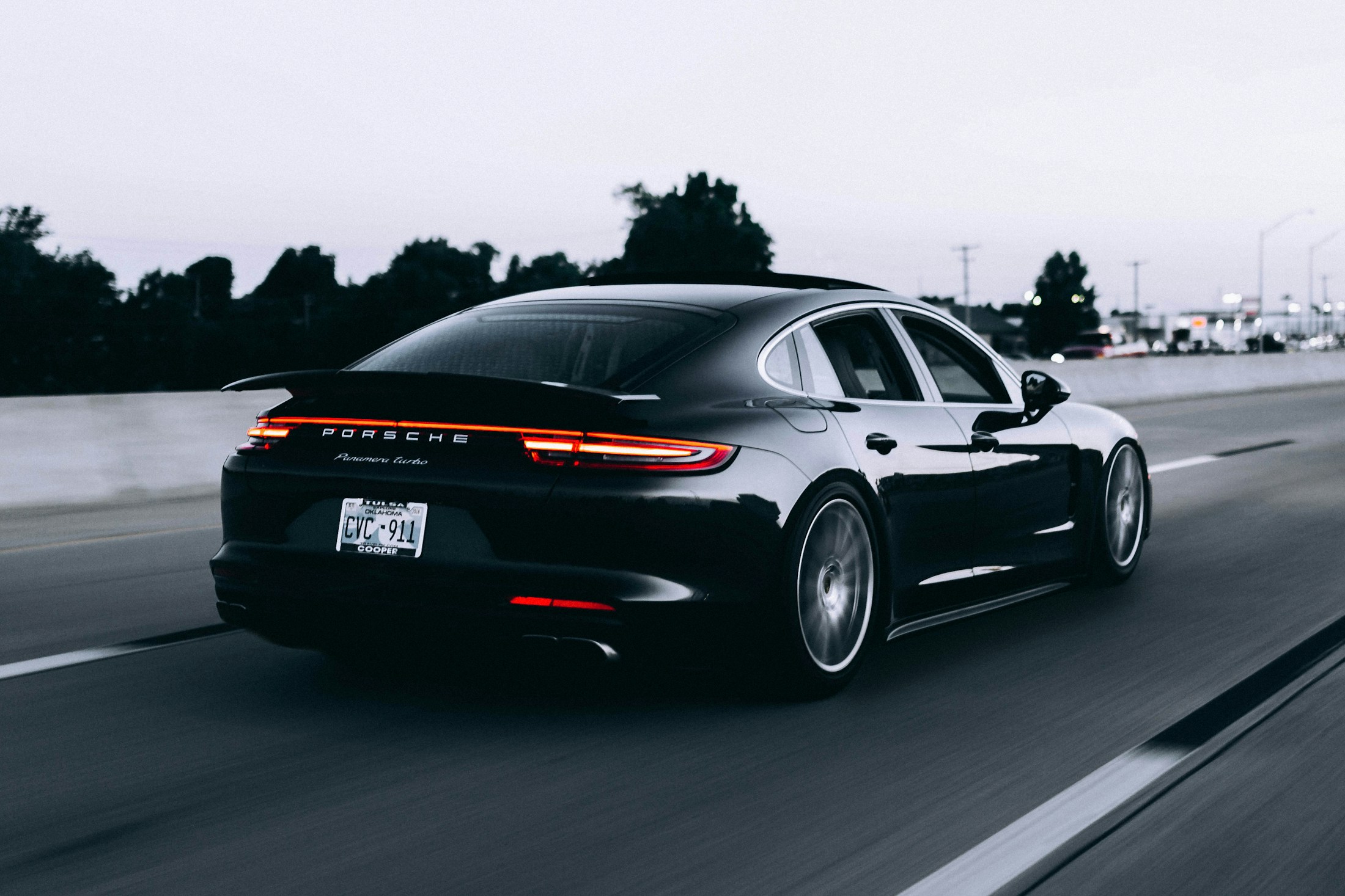 A polished dark sports car on the road