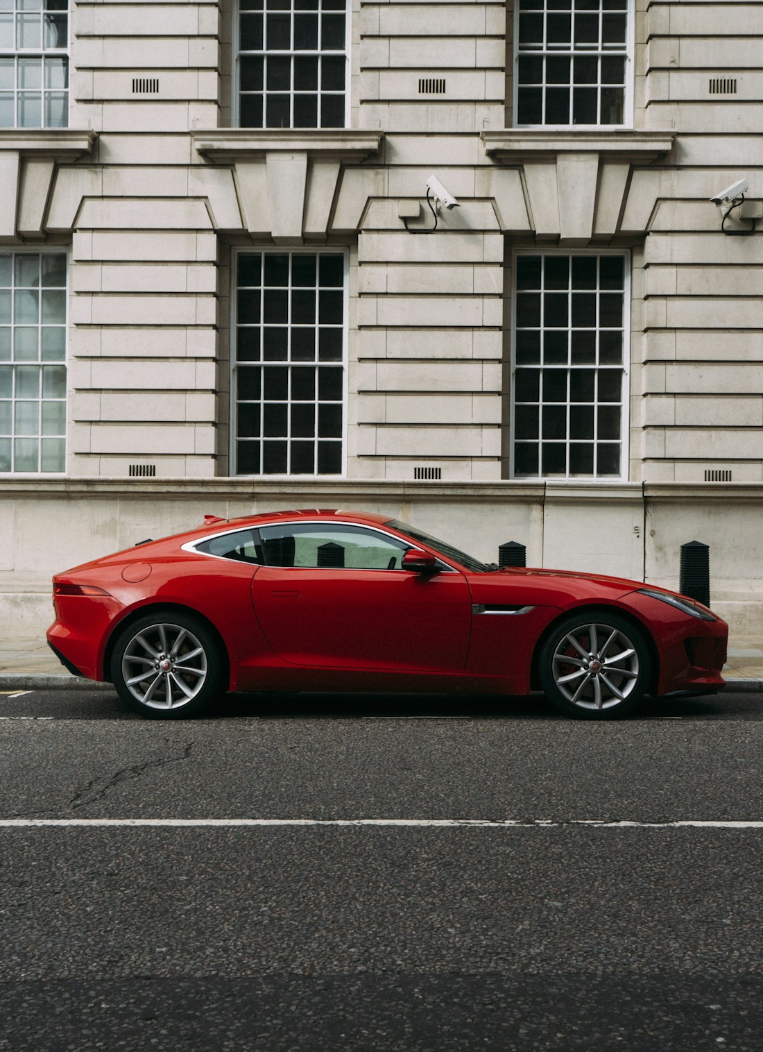 A red sports car parked on a city street